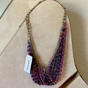 A silver necklace with blue and pink/purple beads